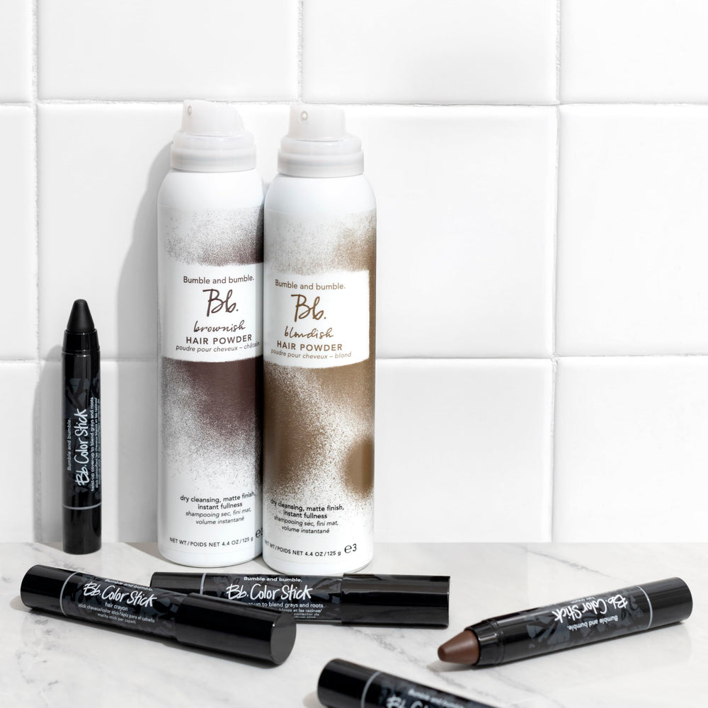 Bumble and bumble Color Stick inside a handbag showing convenience for on-the-go root camouflage