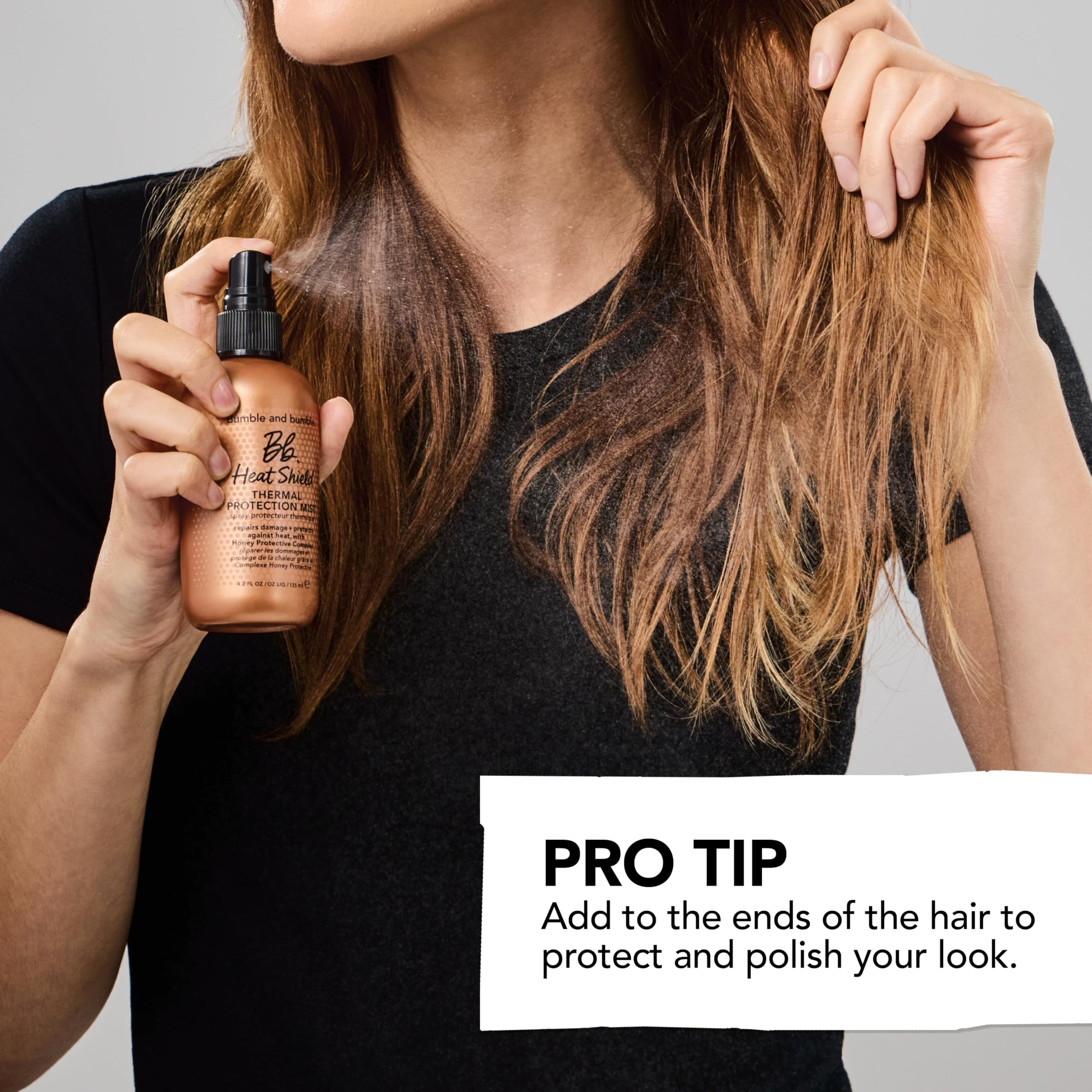 Bumble and bumble mini bottle held in hand for compact size and travel convenience