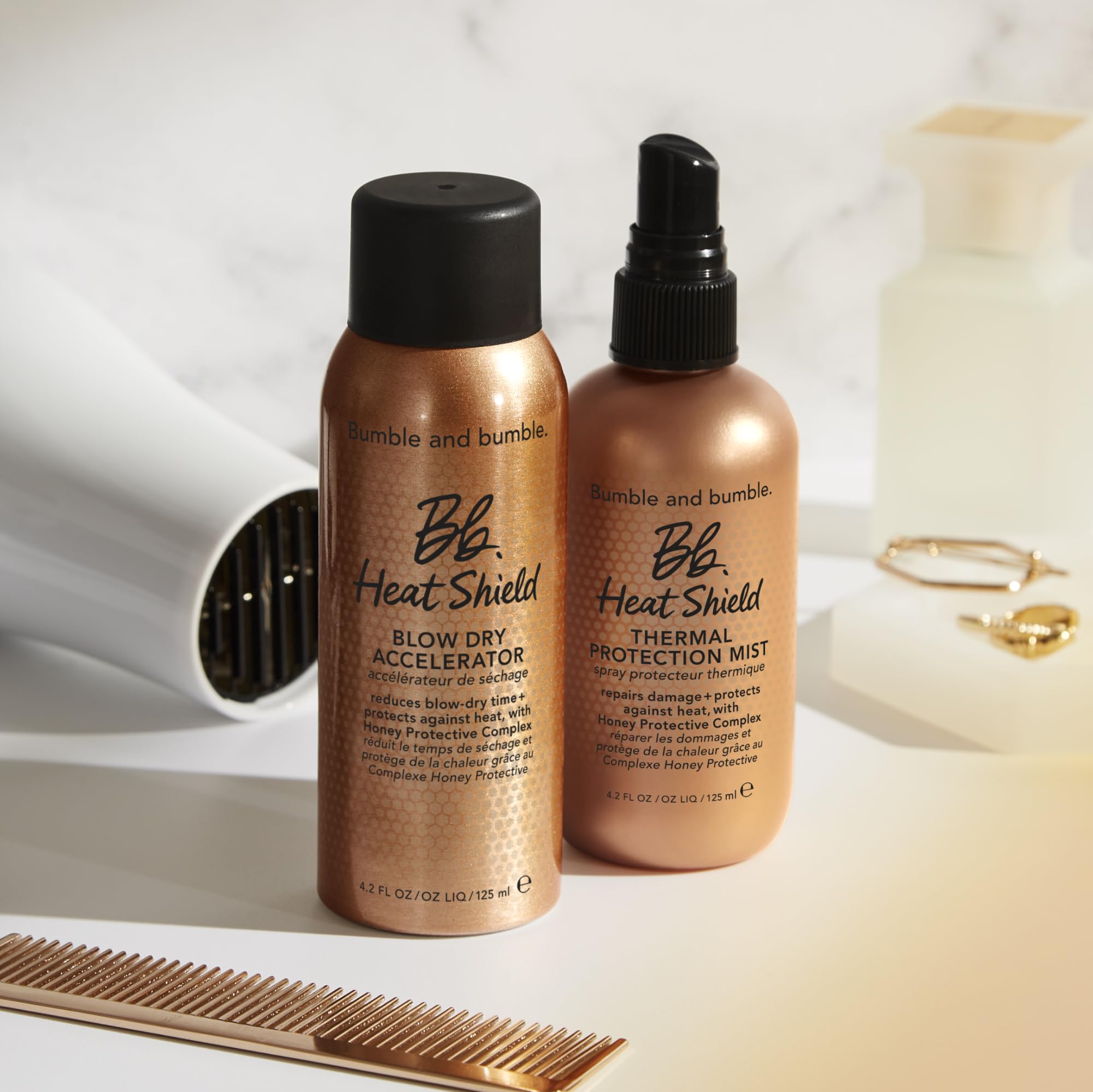 Bumble and bumble Heat Shield beside common items for scale, shows the 4.2 fl oz travel-friendly benefit
