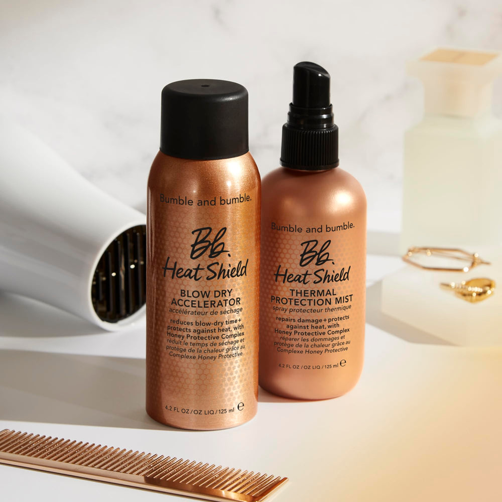 Bumble and bumble Heat Shield beside common items for scale, shows the 4.2 fl oz travel-friendly benefit