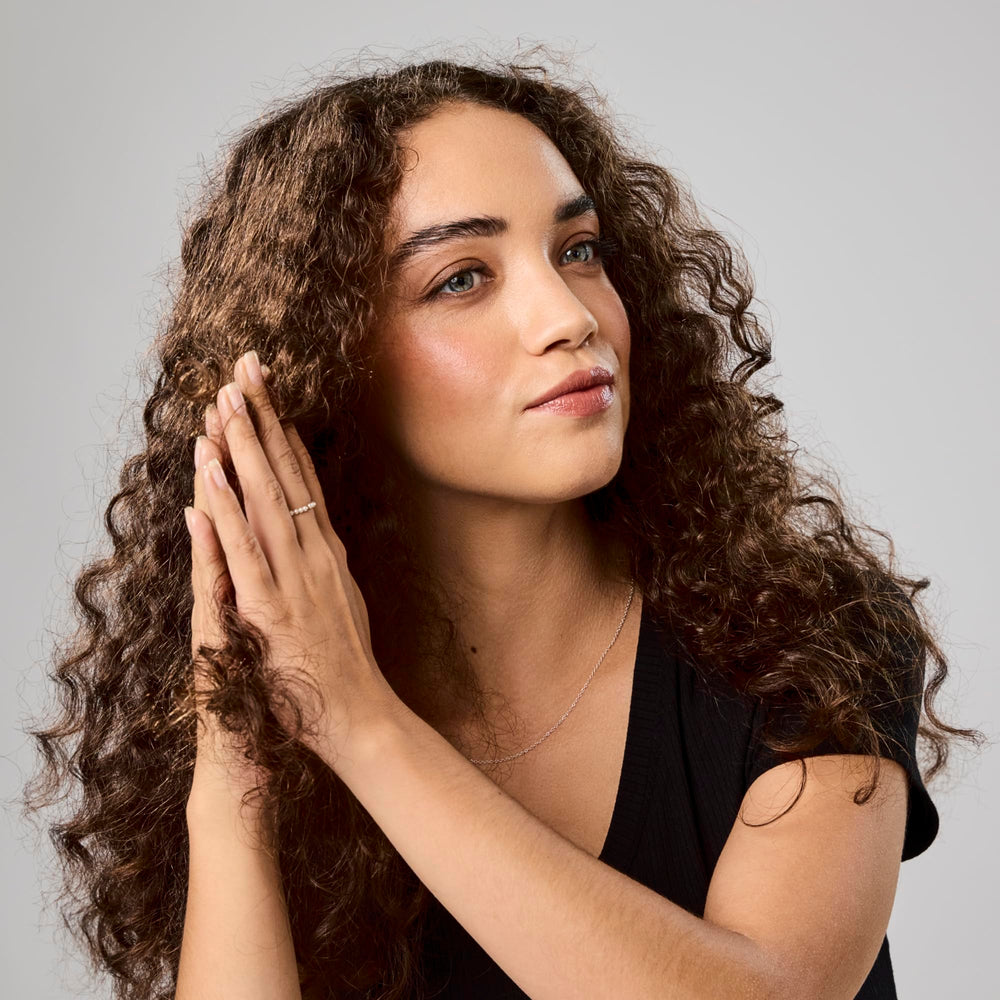 Bumble and bumble oil on hair ends close-up smoothing split ends and adding shine