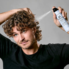 Bumble and bumble bottle held in hand showing size and portability benefit