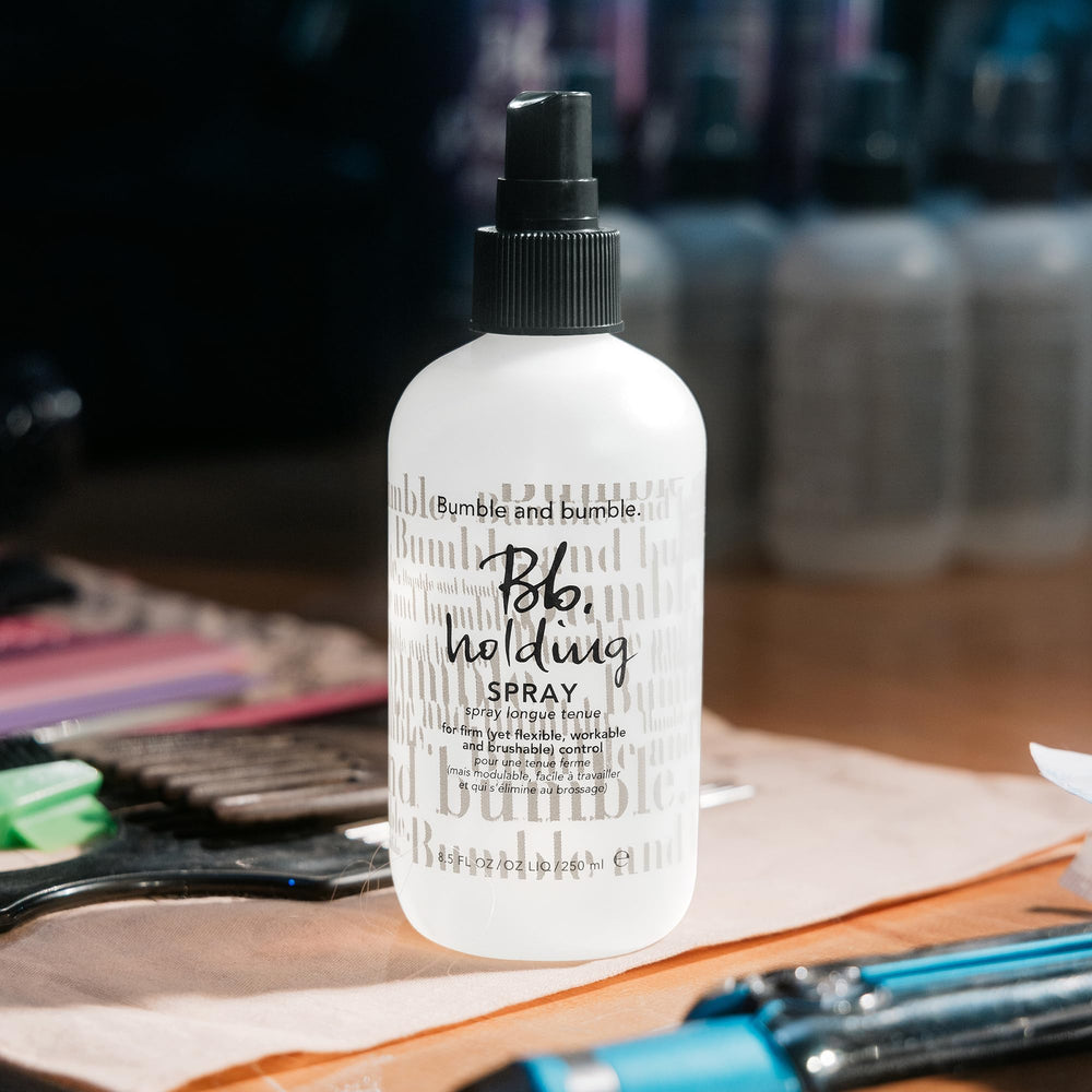 bumble and bumble bottle held in hand for scale and easy salon-friendly size