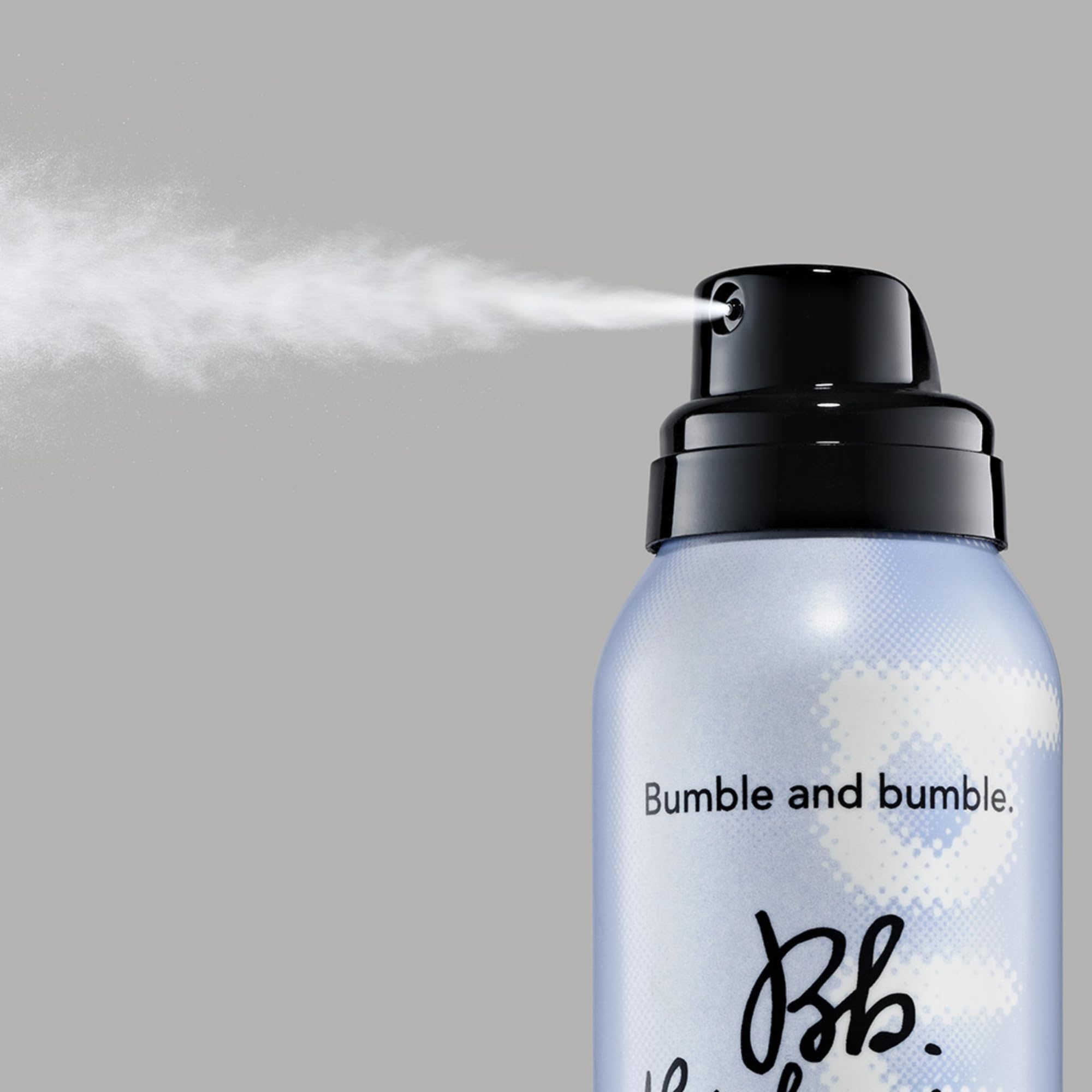 Bumble and bumble being sprayed onto wavy hair adding tousled movement