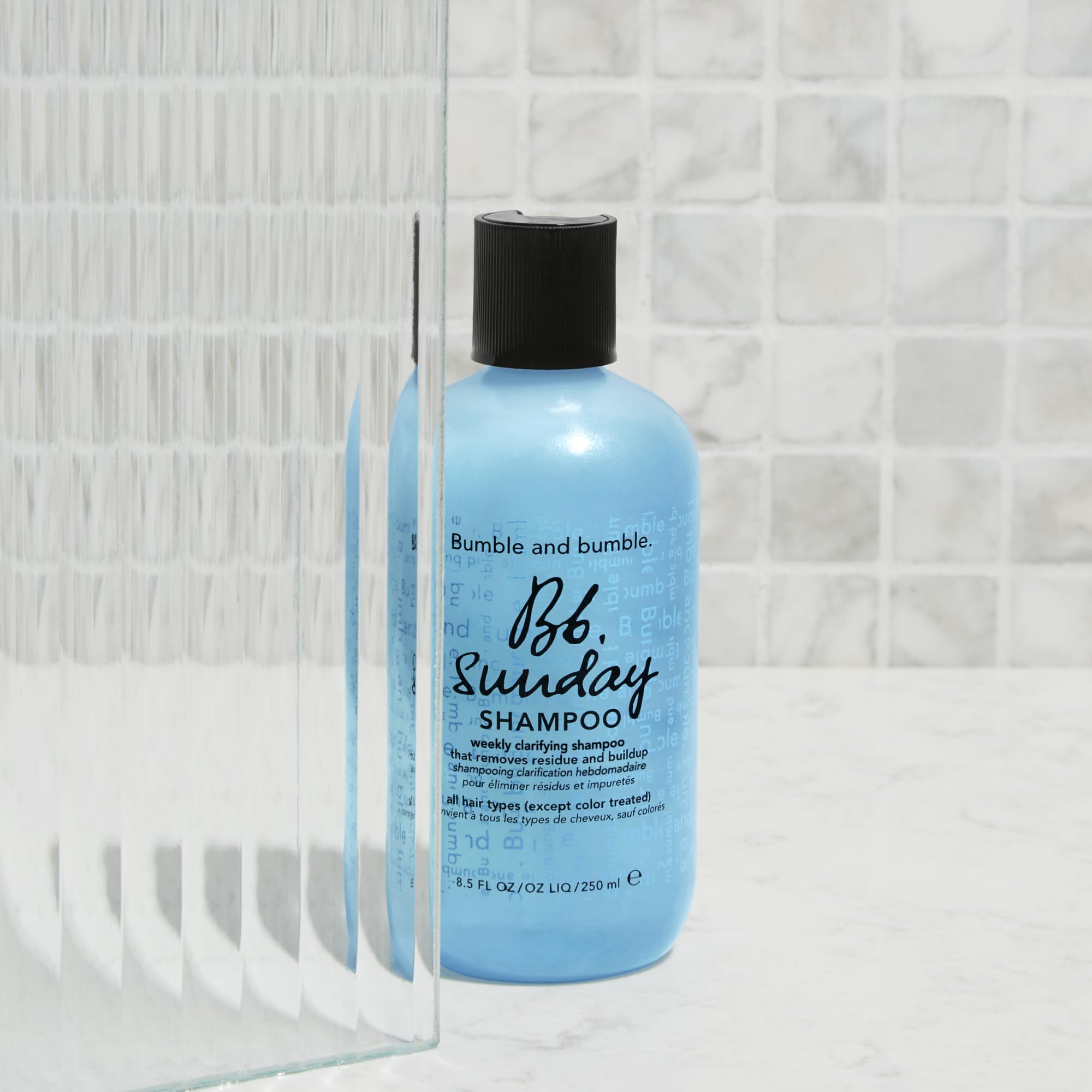 Bumble and bumble bottle on bathroom vanity suggesting travel-ready freshness