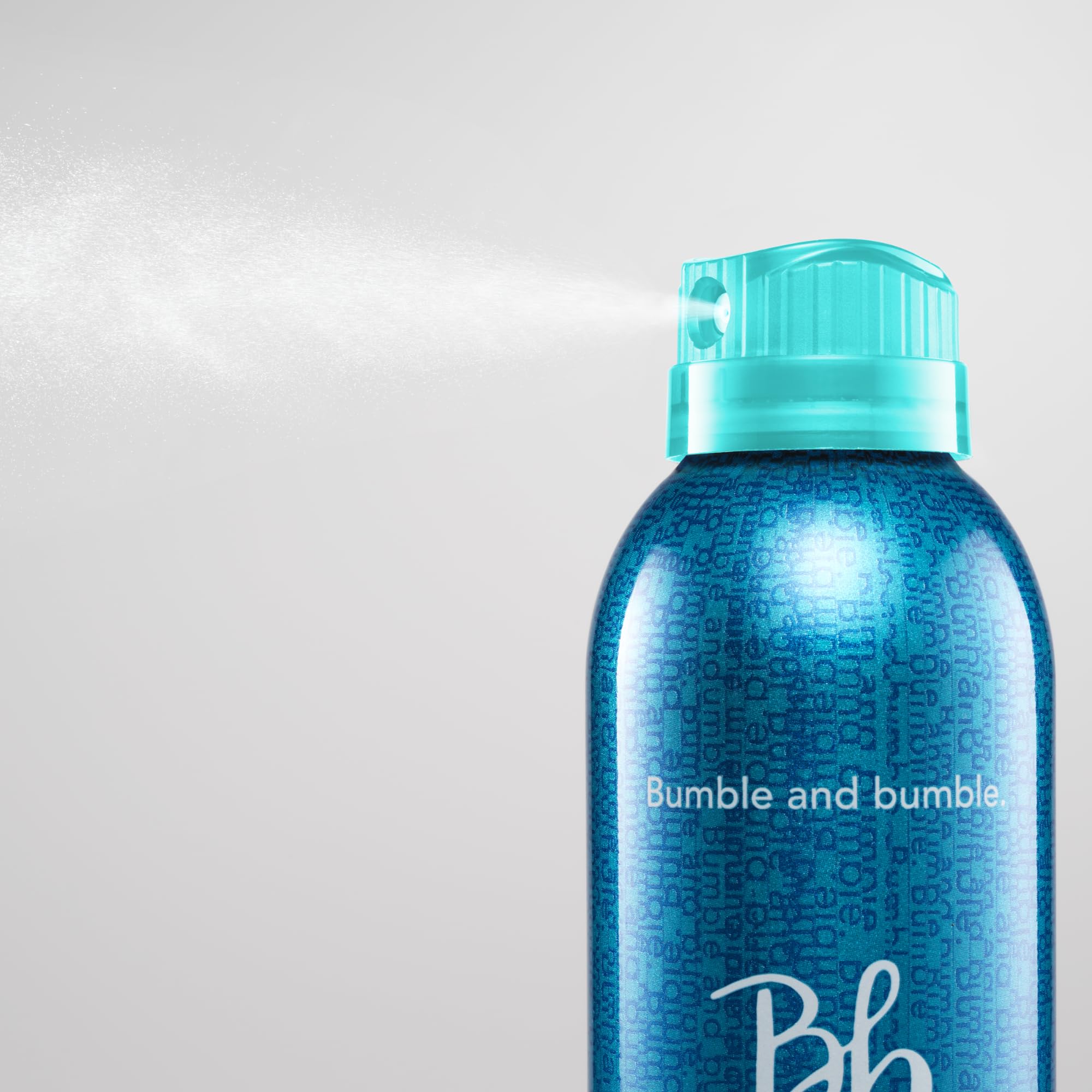 Bumble and bumble close-up on textured hair showing touchable, brushable finish benefit