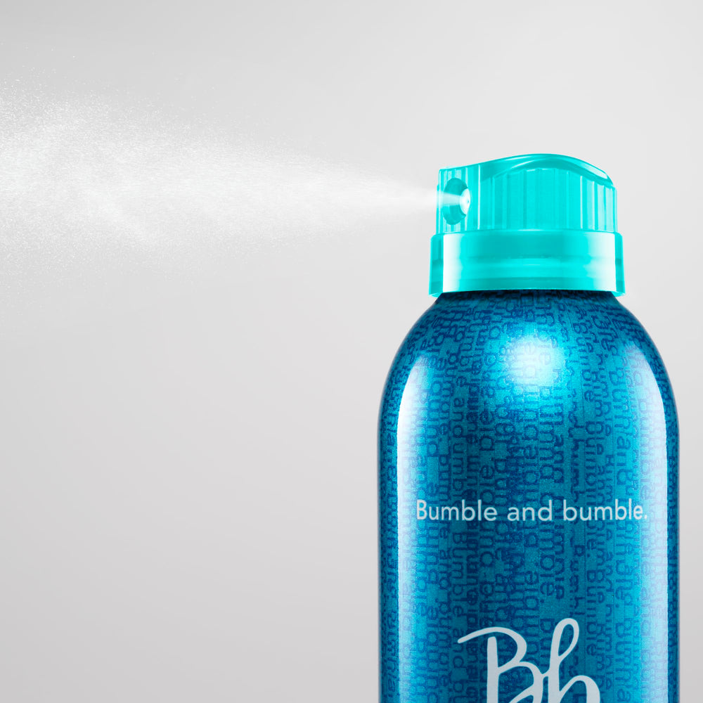 Bumble and bumble close-up on textured hair showing touchable, brushable finish benefit