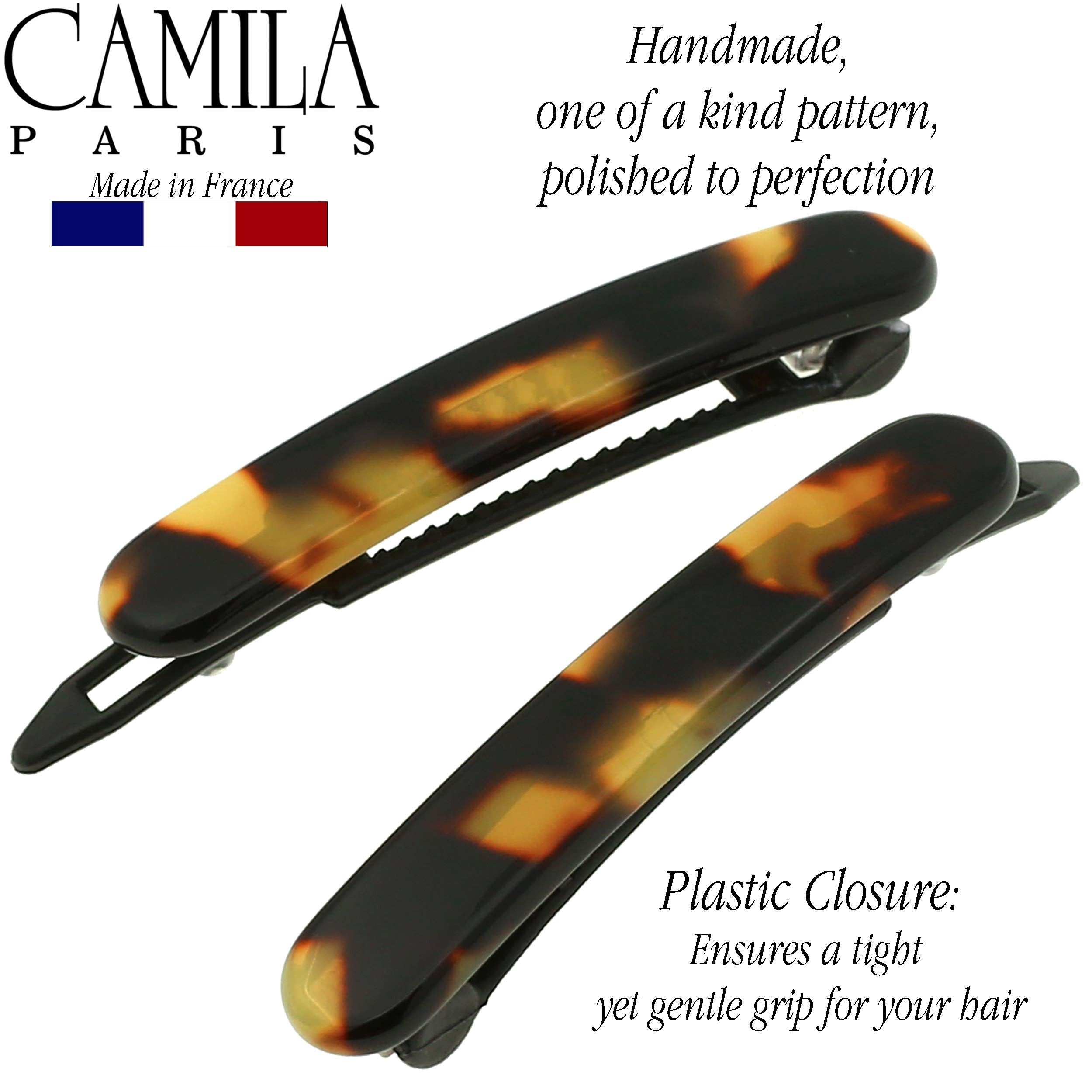 Camila Paris next to coin for scale to show compact 1.75-inch size
