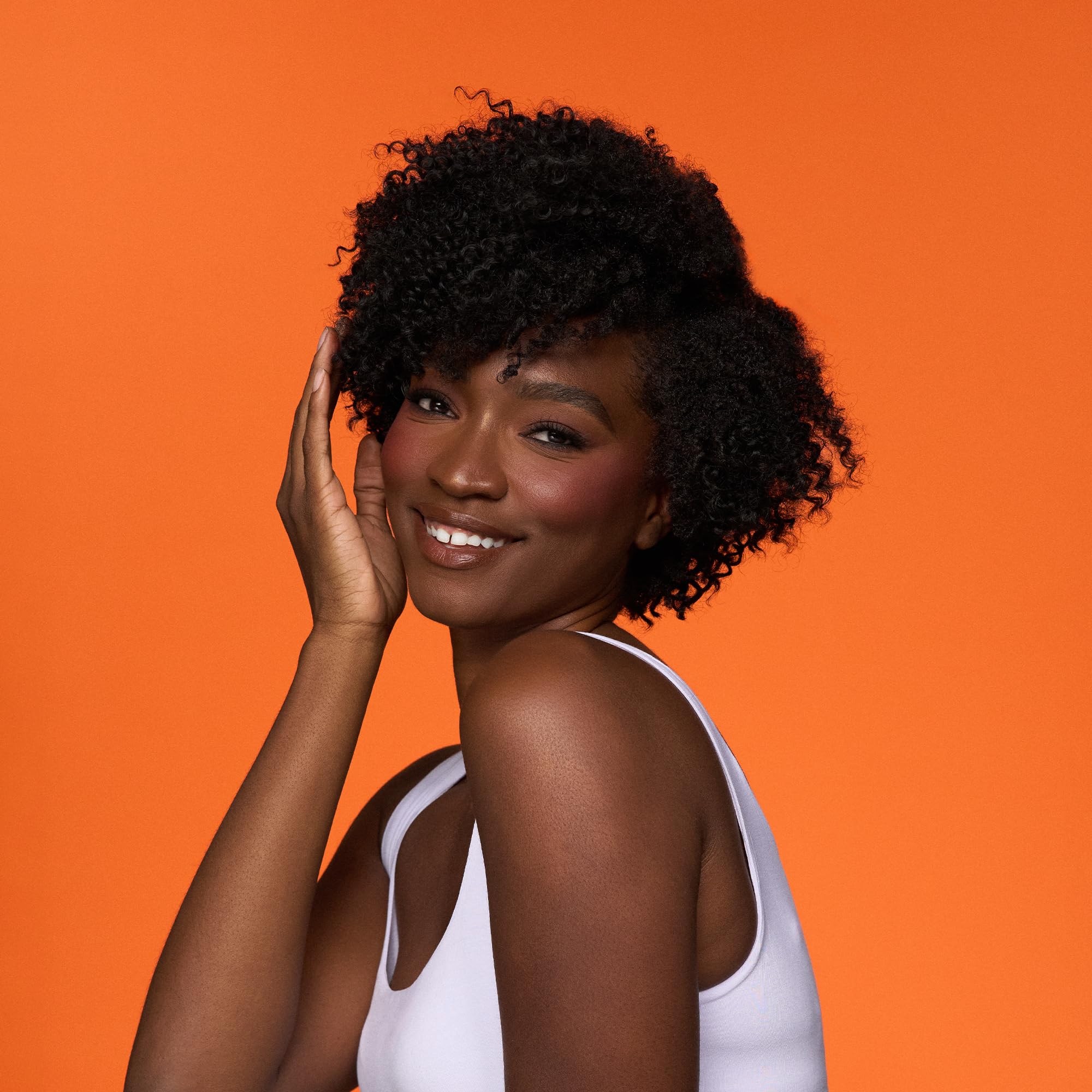 Camille Rose lifestyle shot of a woman refreshing curls at home for convenience