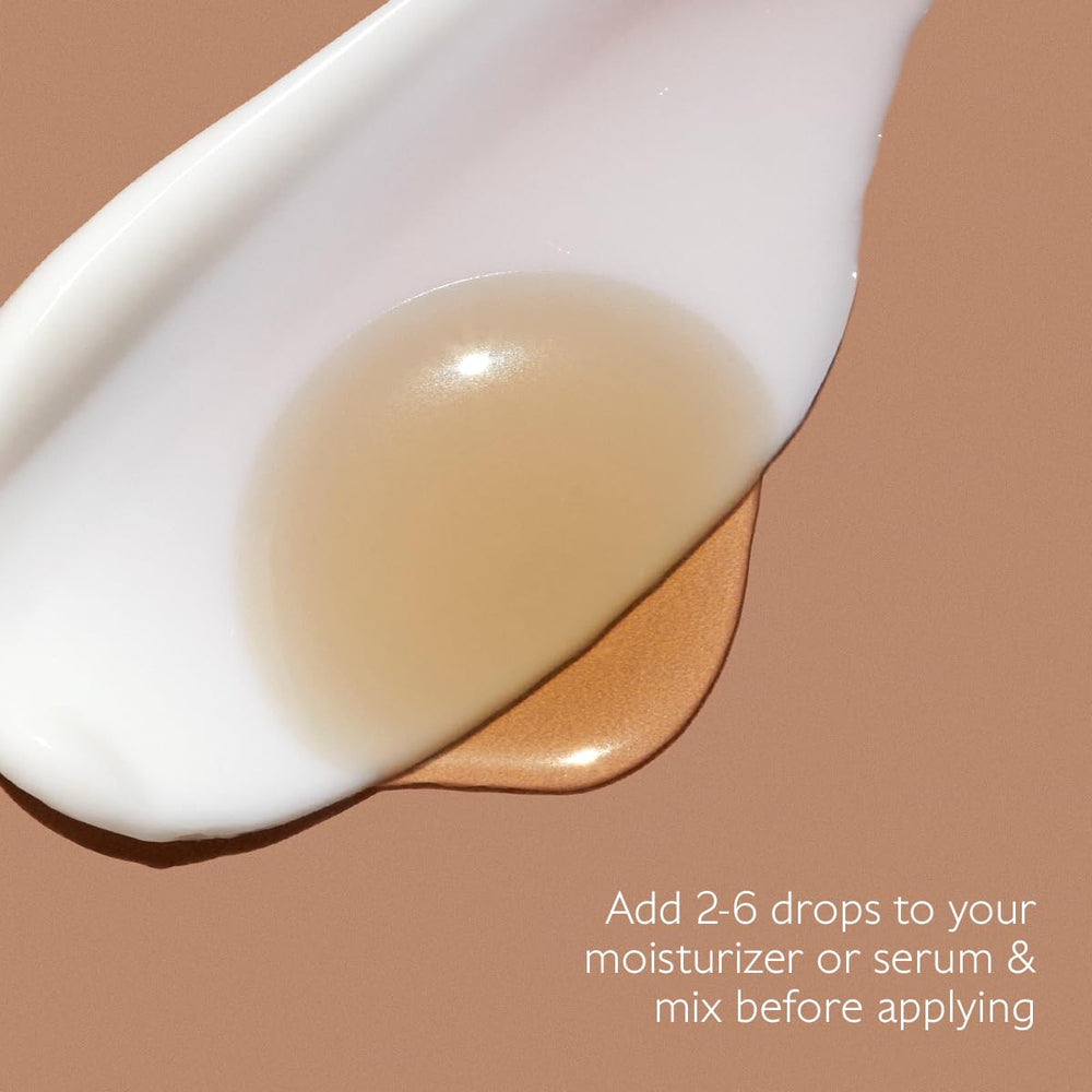 Caudalie bottle next to hand for scale showing compact travel size