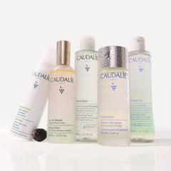Caudalie Vinoclean next to hand for scale showing compact 100 mL travel-friendly size