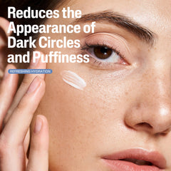 Woman applying Cetaphil eye serum under-eye with applicator for reduced puffiness