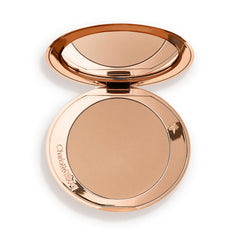 Charlotte Tilbury compact front view showing sleek packaging and portability
