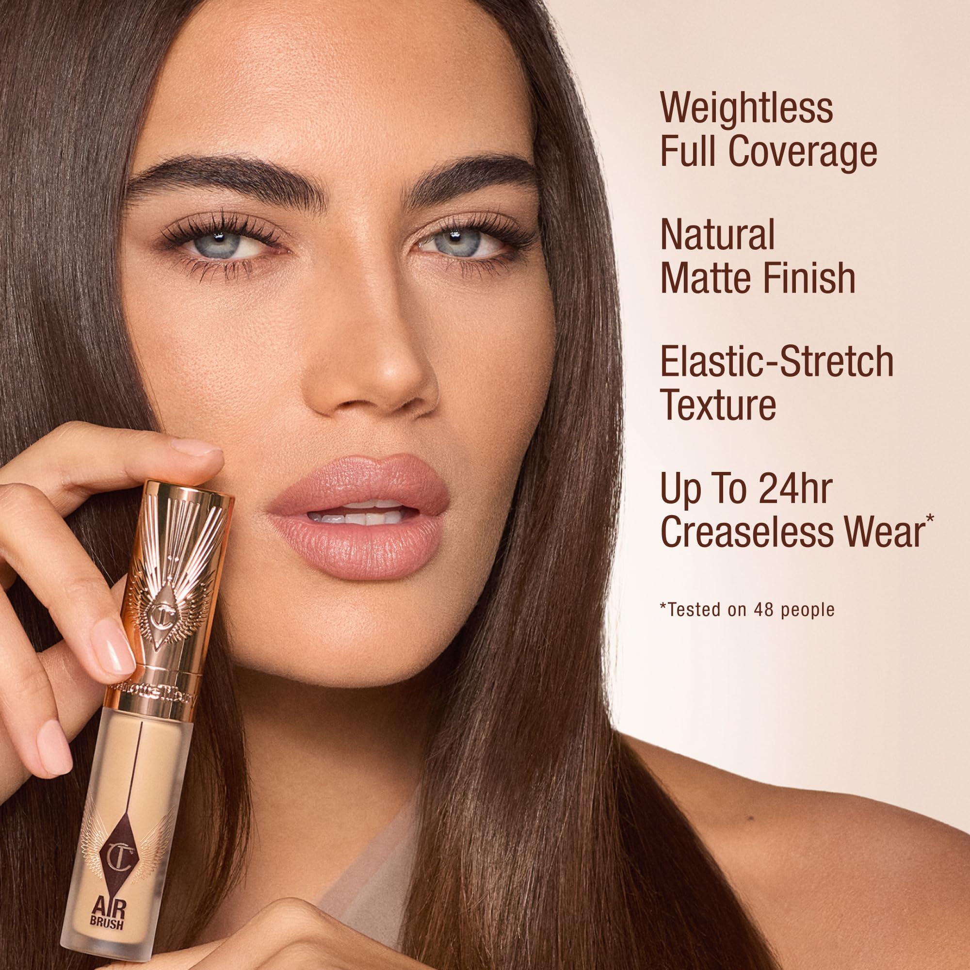 Charlotte Tilbury applying concealer under eye for crease-resistant coverage