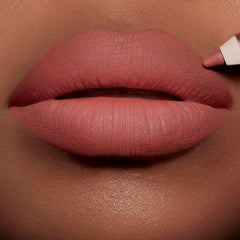 Charlotte Tilbury lip application close-up showing defined edges and natural fuller look