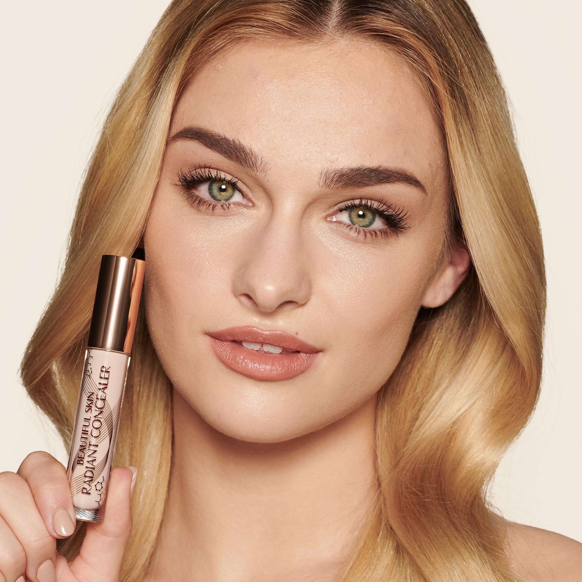 Charlotte Tilbury concealer held in hand showing product size and portability