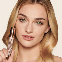 Charlotte Tilbury concealer held in hand showing product size and portability