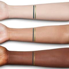 Charlotte Tilbury metallic tip swatch on skin showing luminous finish and brightening effect