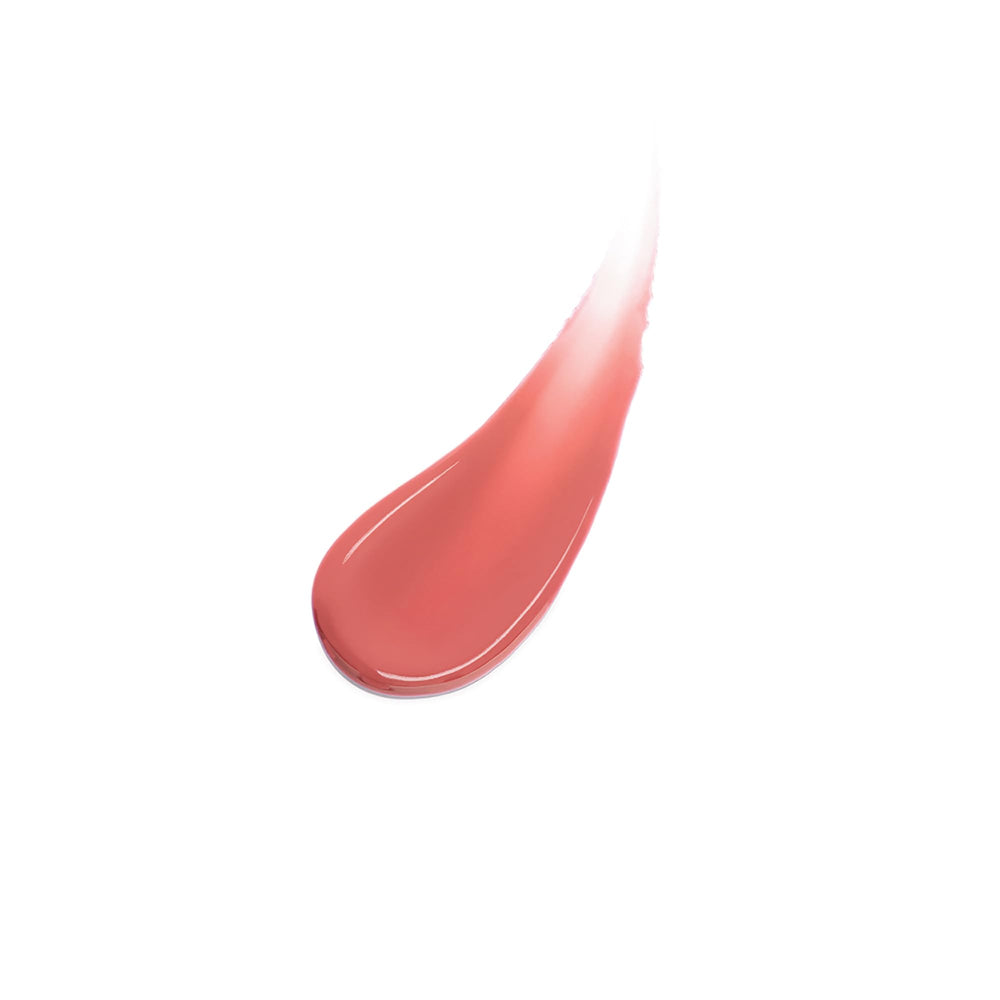 Charlotte Tilbury swatch on arm showing sheer berry-pink shade and blendability