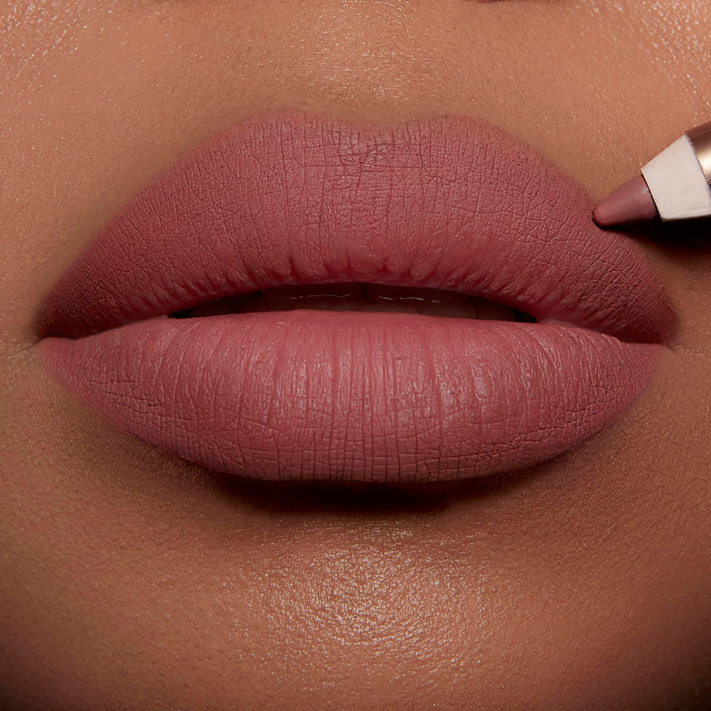 Charlotte Tilbury Love Trap swatches on arm showing peachy-brown payoff