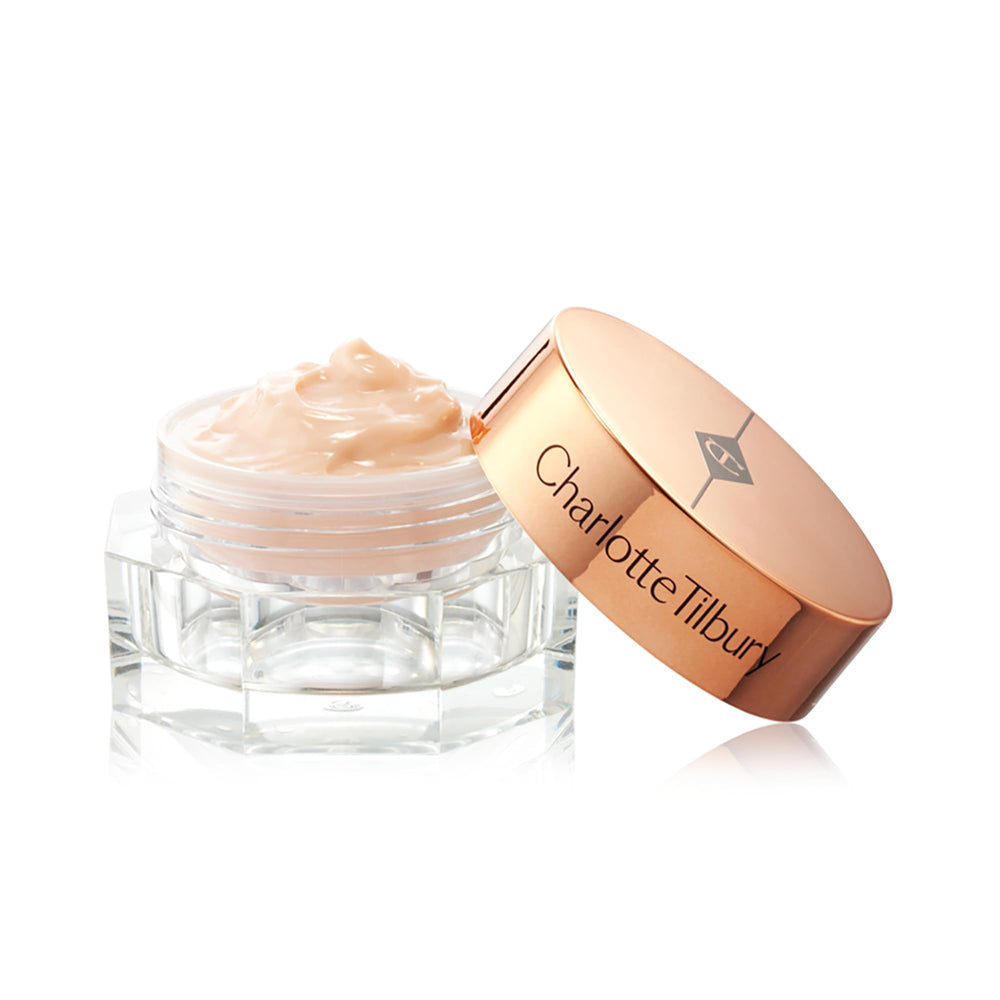 Charlotte Tilbury jar held in hand showing scale and travel-friendly convenience