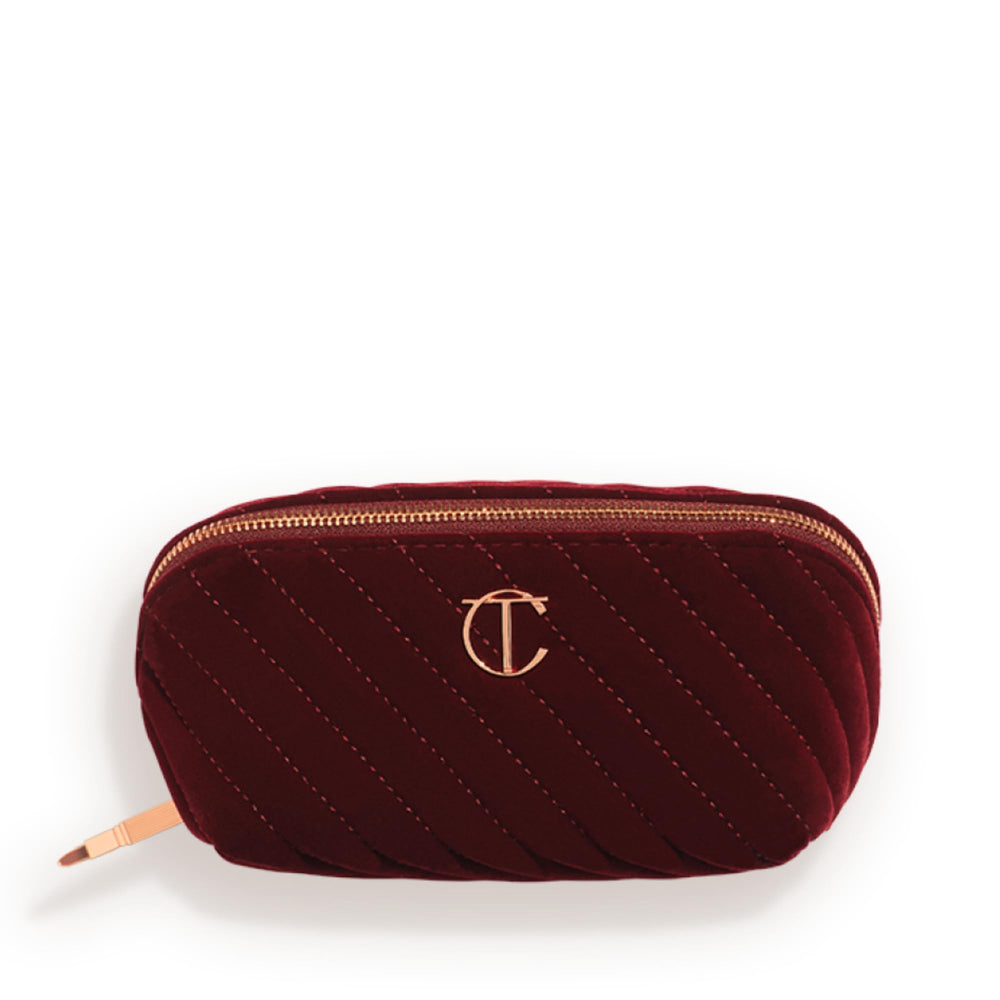 Charlotte Tilbury medium quilted velvet bag front view showing elegant night crimson finish and travel-ready style