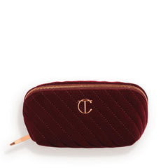 Charlotte Tilbury medium quilted velvet bag front view showing elegant night crimson finish and travel-ready style