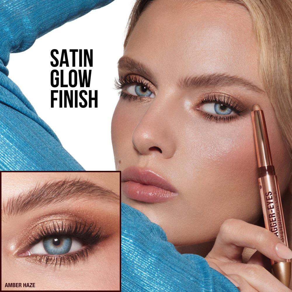 Charlotte Tilbury eyeshadow stick beside fingers showing portable size