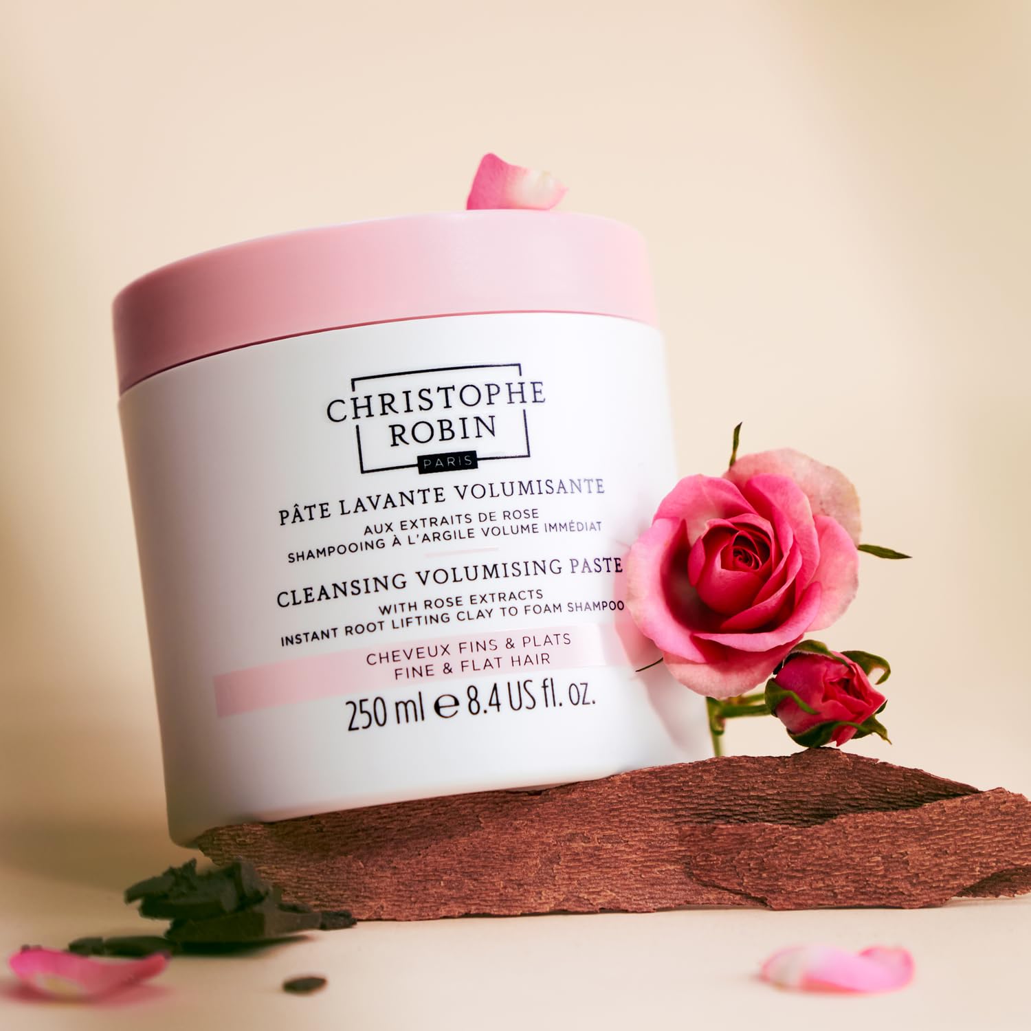 Christophe Robin 8.4 fl oz next to hand showing size and travel convenience