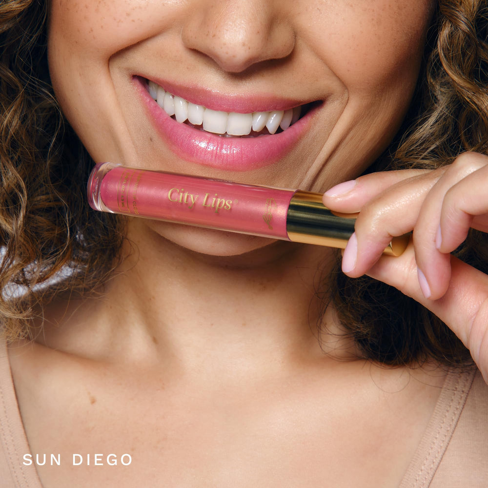 City Beauty swatch of Sun Diego shade on skin showing warm pink with gold shimmer