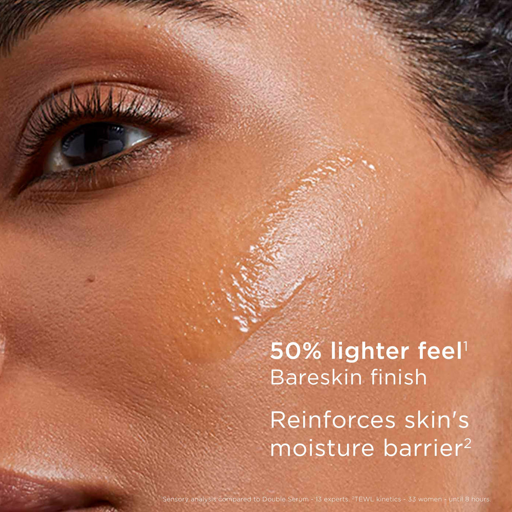Clarins double serum light beside hand for size comparison showing travel convenience benefit