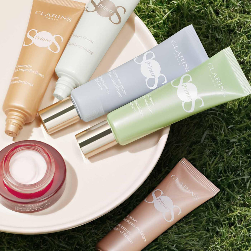Clarins primer on vanity with brush illustrating ready-for-makeup finish