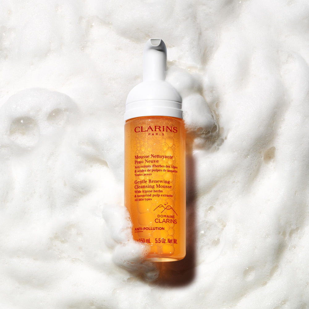 CLARINS bottle in hand demonstrating 5.5 oz size and travel convenience benefit