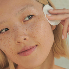 Clarins toner on cotton pad demonstrating gentle removal of residue