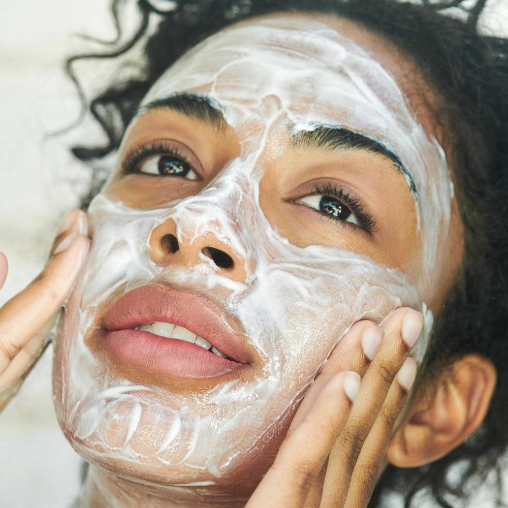 Clarins product in hand illustrating how it spreads and removes makeup easily