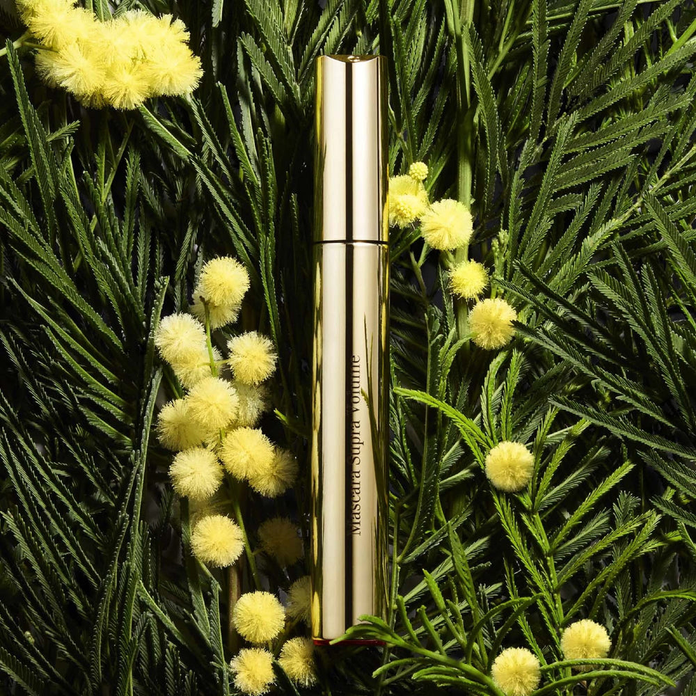 Clarins wand coating on lashes highlighting rich black pigment for intensified lash volume benefit