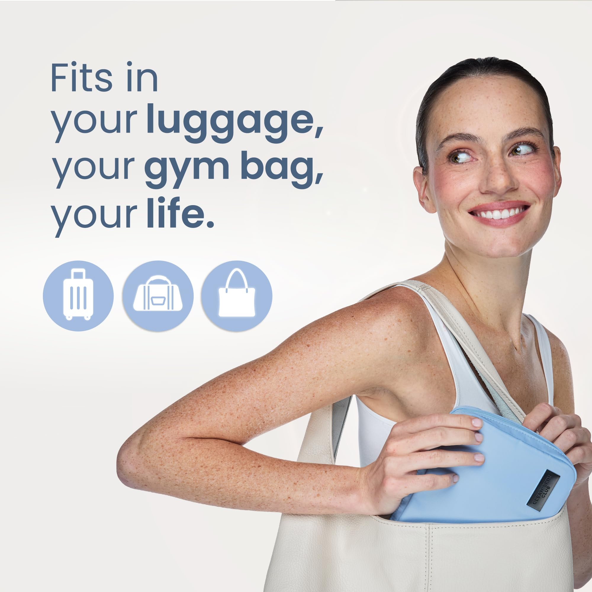CLEAN SKIN CLUB pouch inside carry-on demonstrating space-saving travel packing benefit