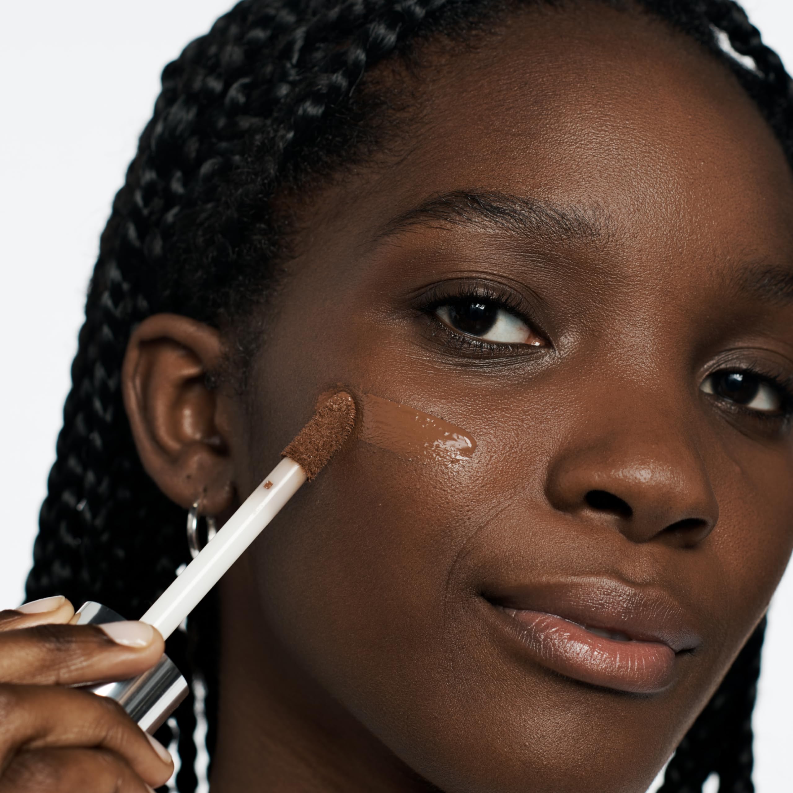 Clinique before-and-after split face showing concealment and refined skin look