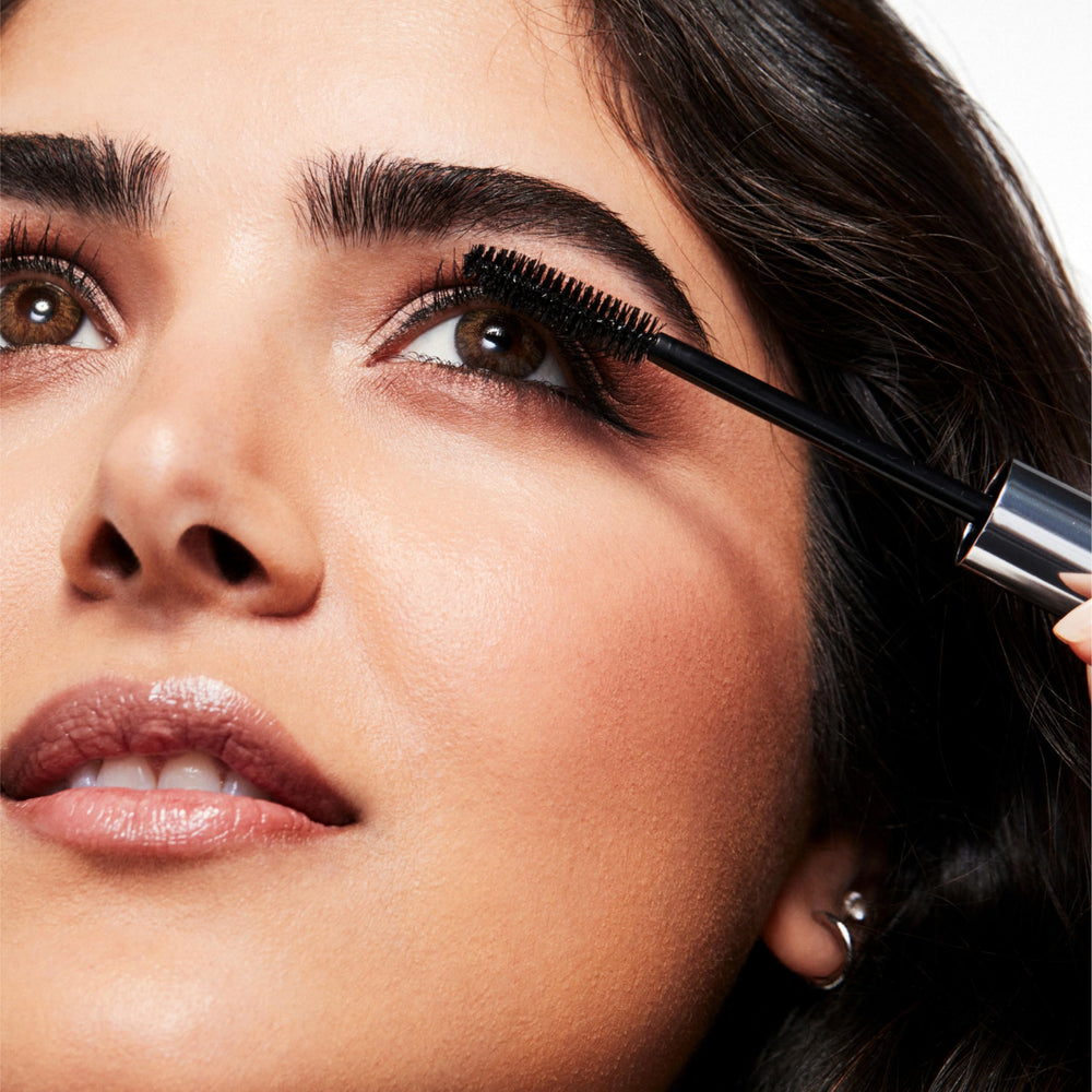 Clinique mascara tube held in hand showing size and travel-friendly benefit