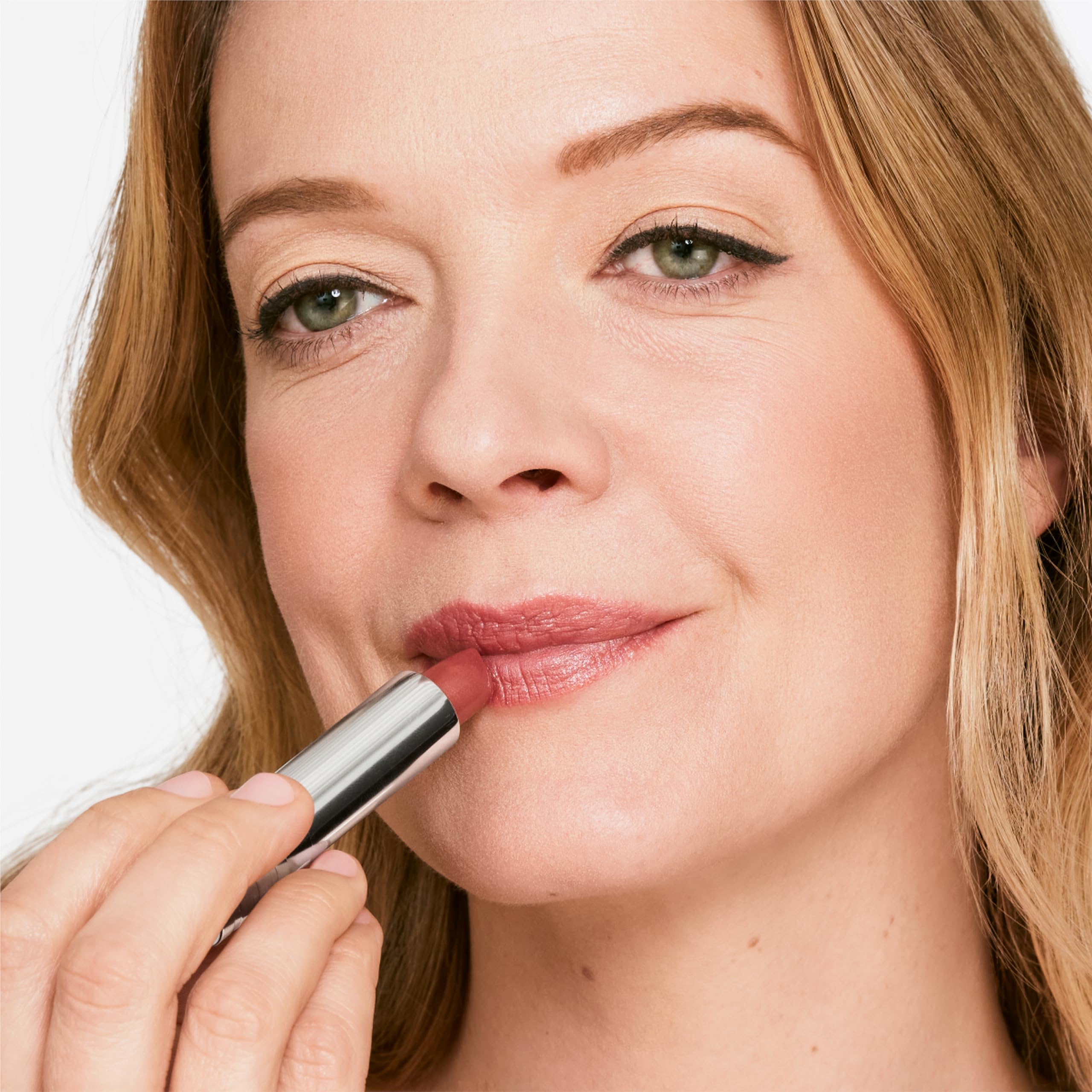 Clinique model wearing lipstick in a lifestyle setting showing defined pout and natural finish benefit
