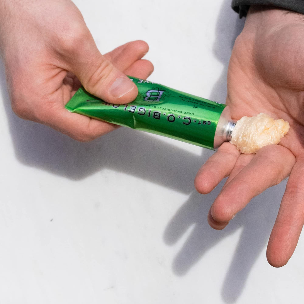 Shaving brush applying C. O. Bigelow cream to face illustrating thicker protective lather