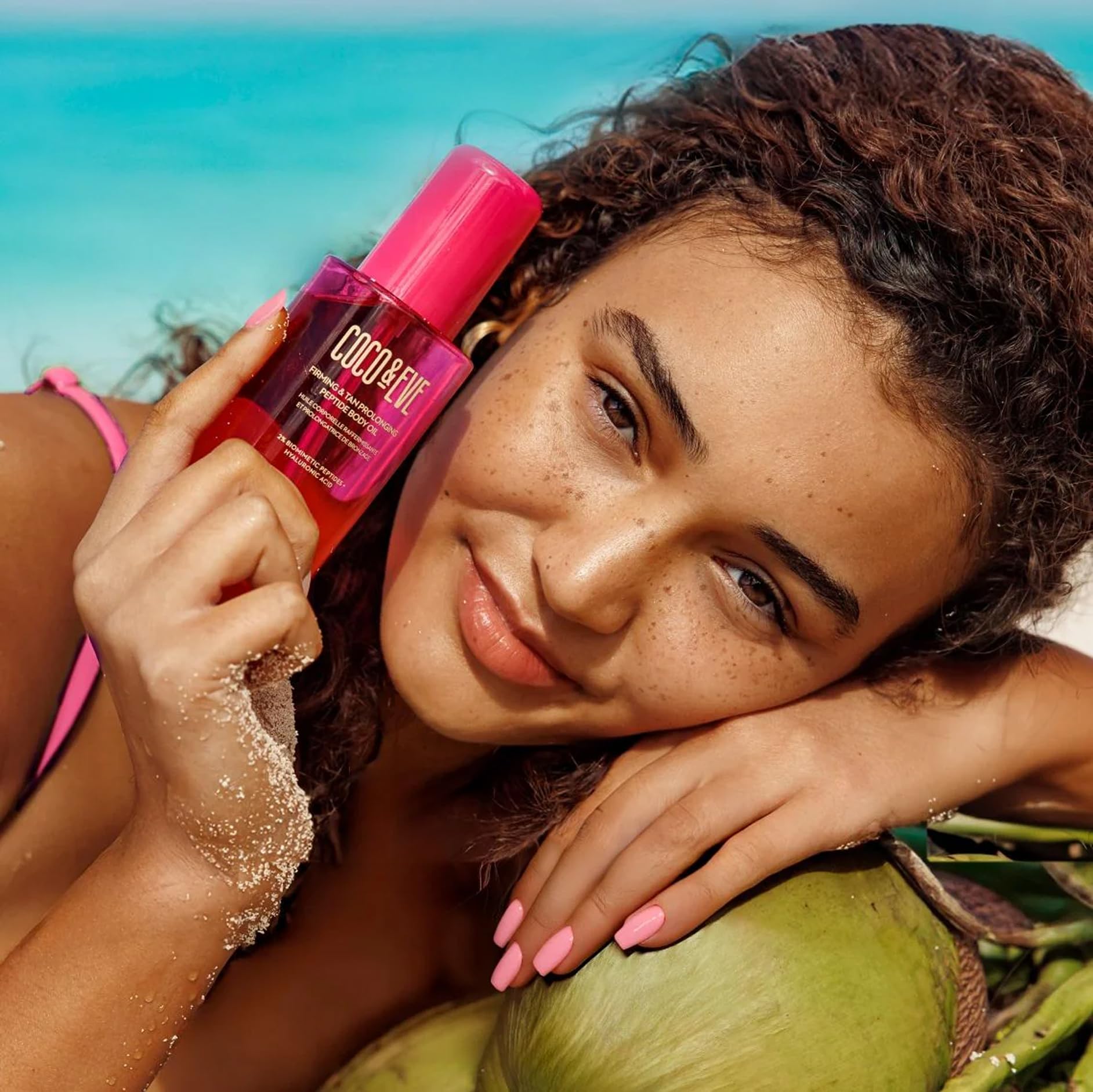 Coco & Eve bottle held in hand to show 5.07 fl oz scale and travel-friendly size benefit