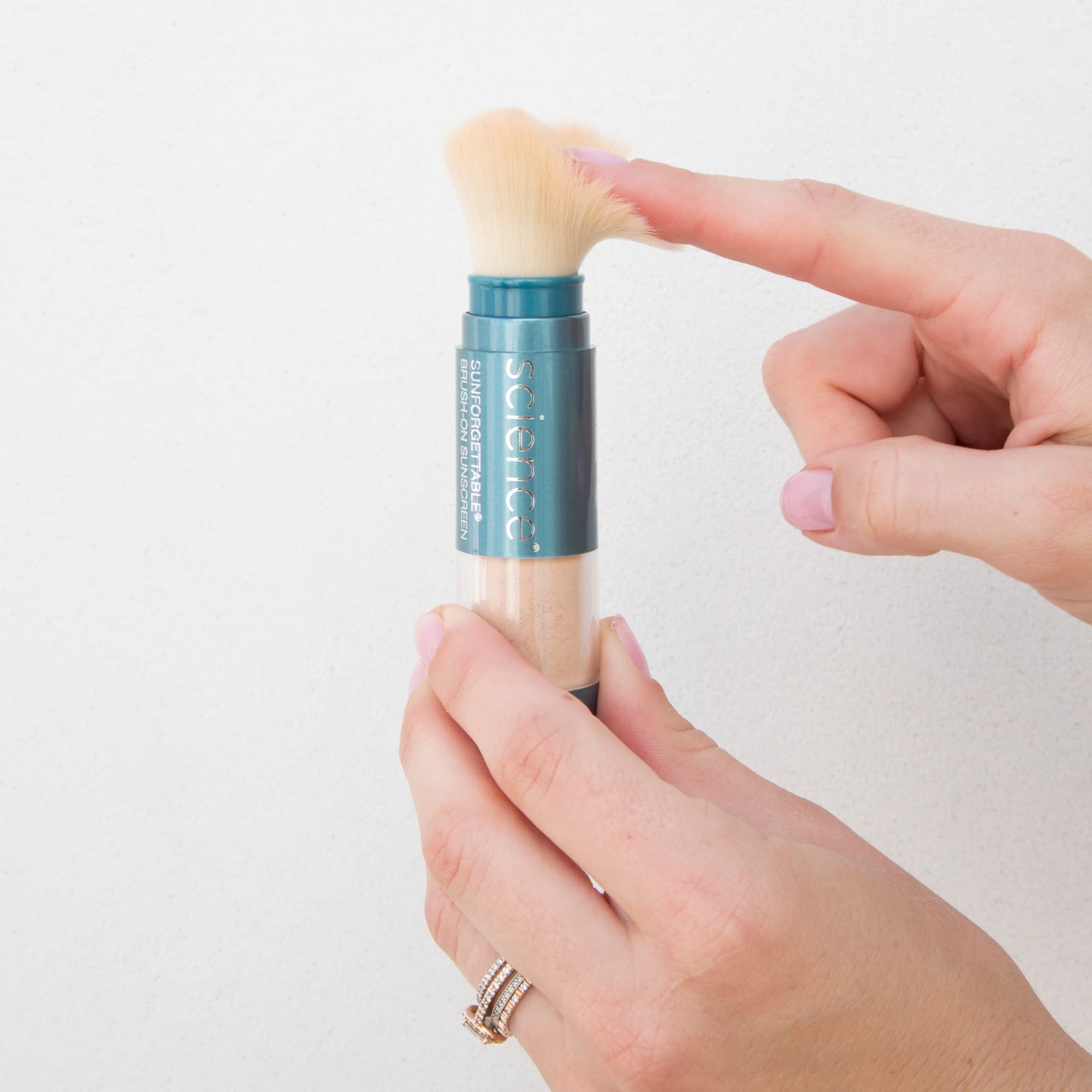 Colorescience brush-on shield applied over makeup showing non-disruptive finish benefit