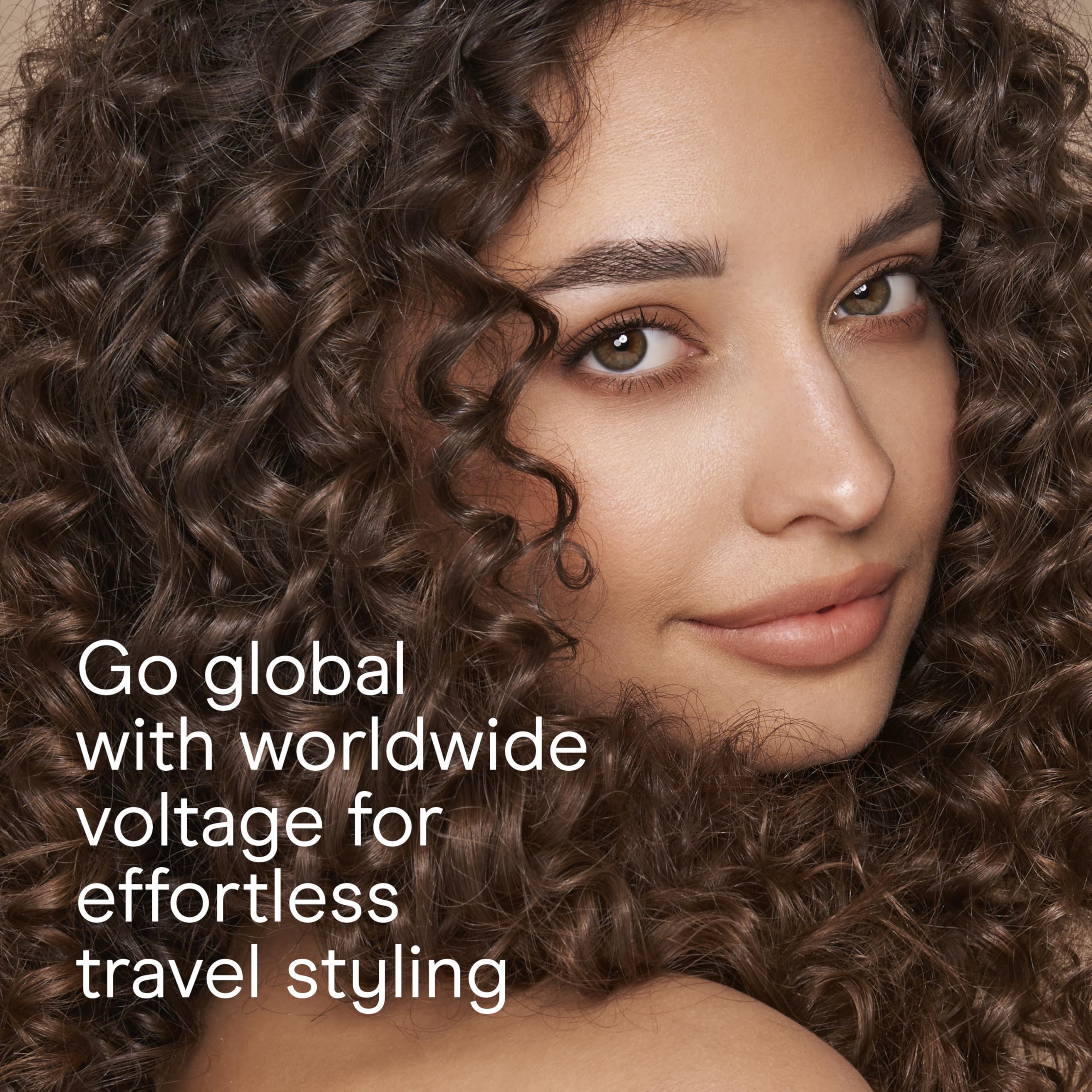 Conair curling iron plugged with dual voltage adapter to illustrate travel-ready flexibility