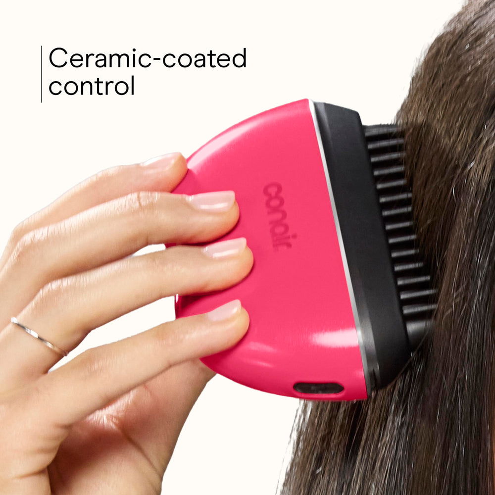 Conair brush beside hand showing scale and portable size for easy carrying