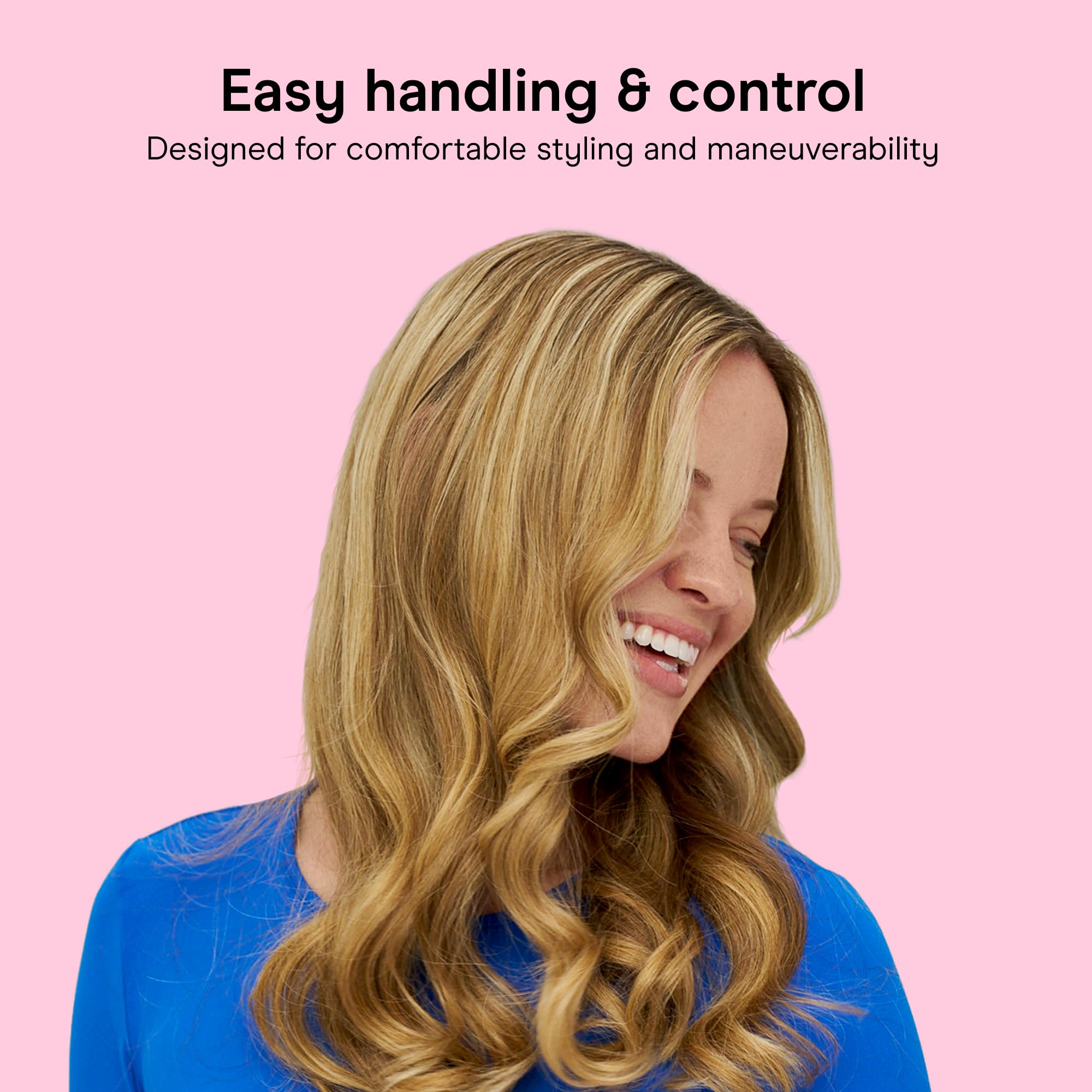 Conair curling iron next to a hand to show compact size and easy travel benefit