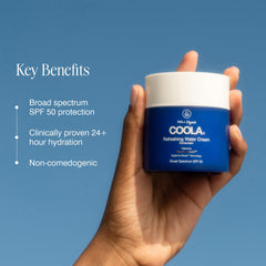 COOLA 1.5 oz in hand illustrating portable size and travel-friendly benefit