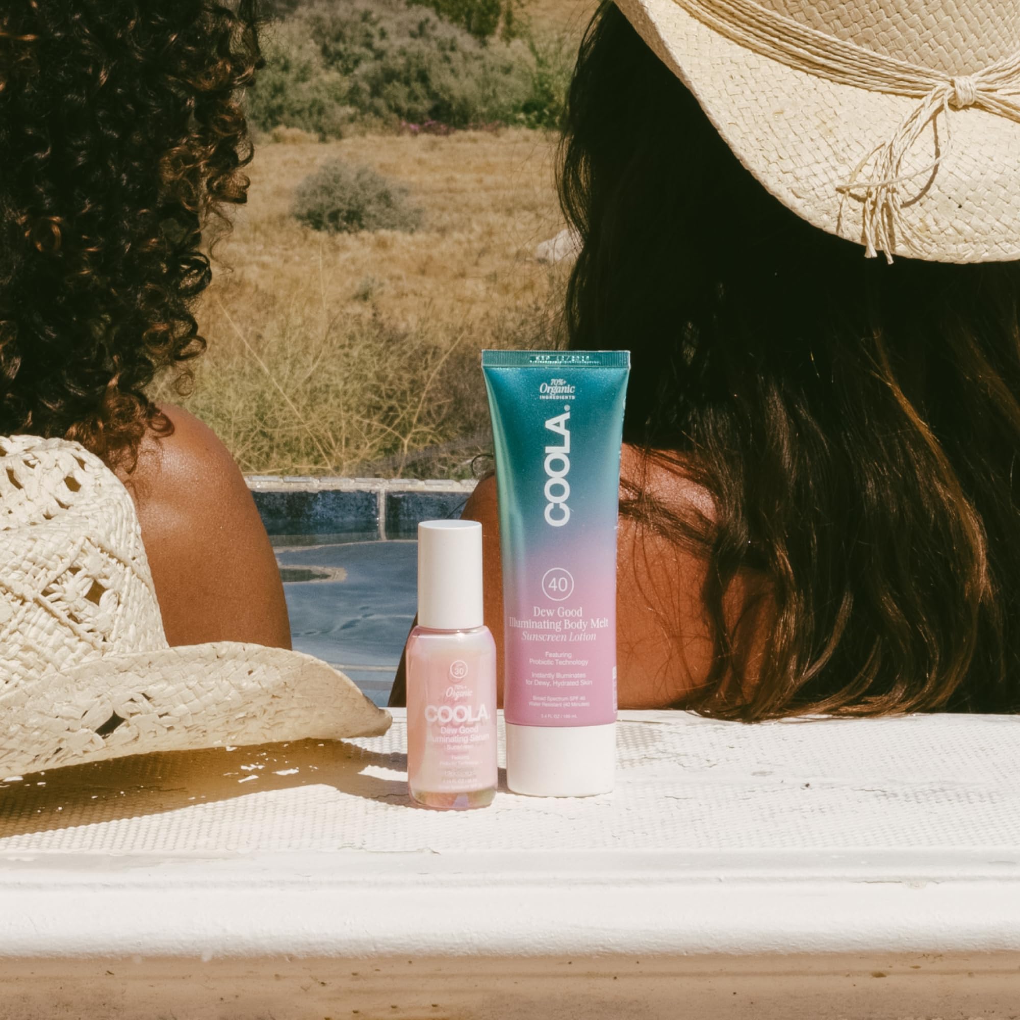 COOLA bottle beside common items to show travel-size convenience benefit