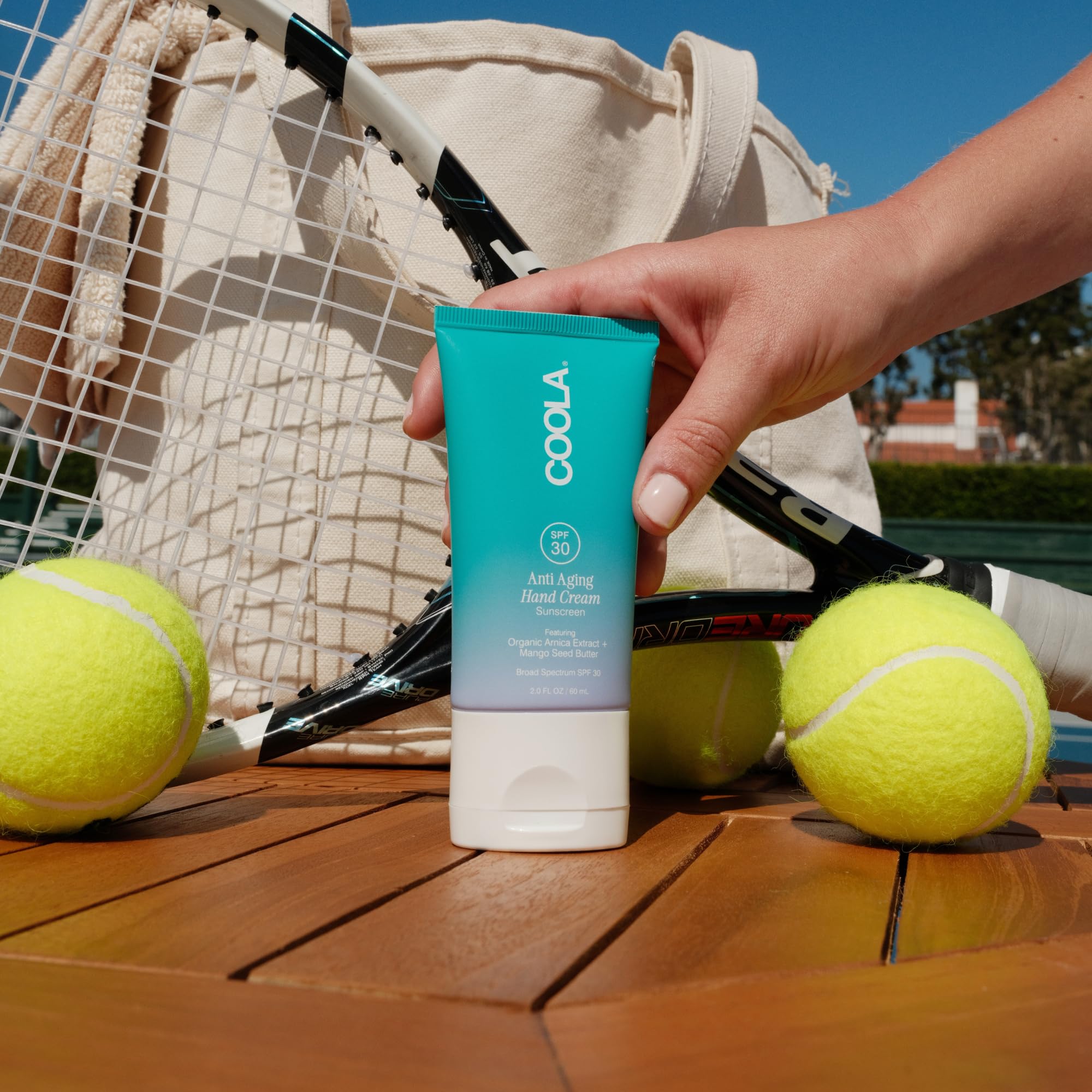 COOLA tube inside a purse ready for on-the-go reapplication
