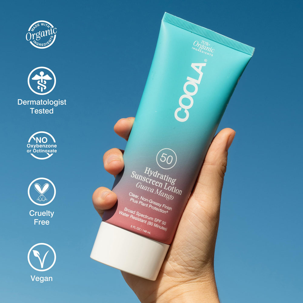 COOLA 5 oz tube in hand for size comparison and travel convenience